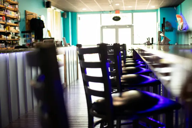 Row of bar stools looking toward the front doors