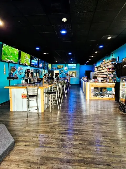 The shop shelves and bar seen from the front of the store