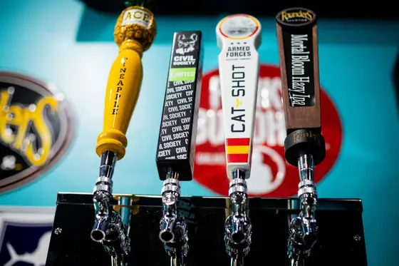 Craft beer tap handles lined up at the bar